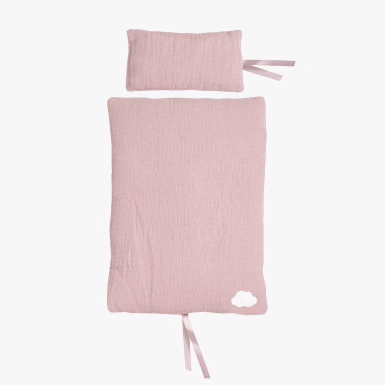 Et lyserosa babyteppe i krinklet stoff med hvit skygrafikk og to bånd, med en matchende pute.