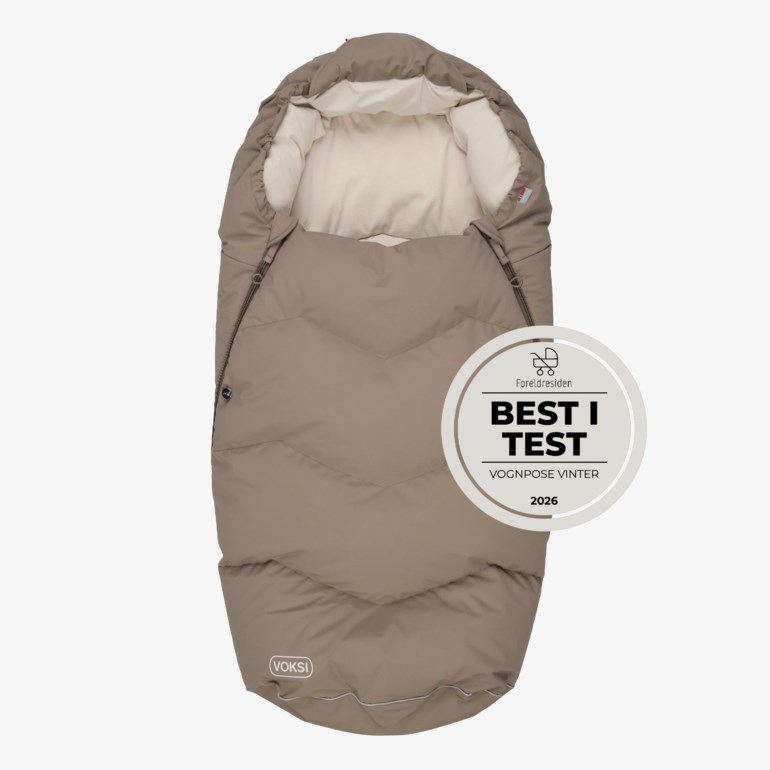 Beige vattert vognpose for baby med hette og glidelåser på sidene.