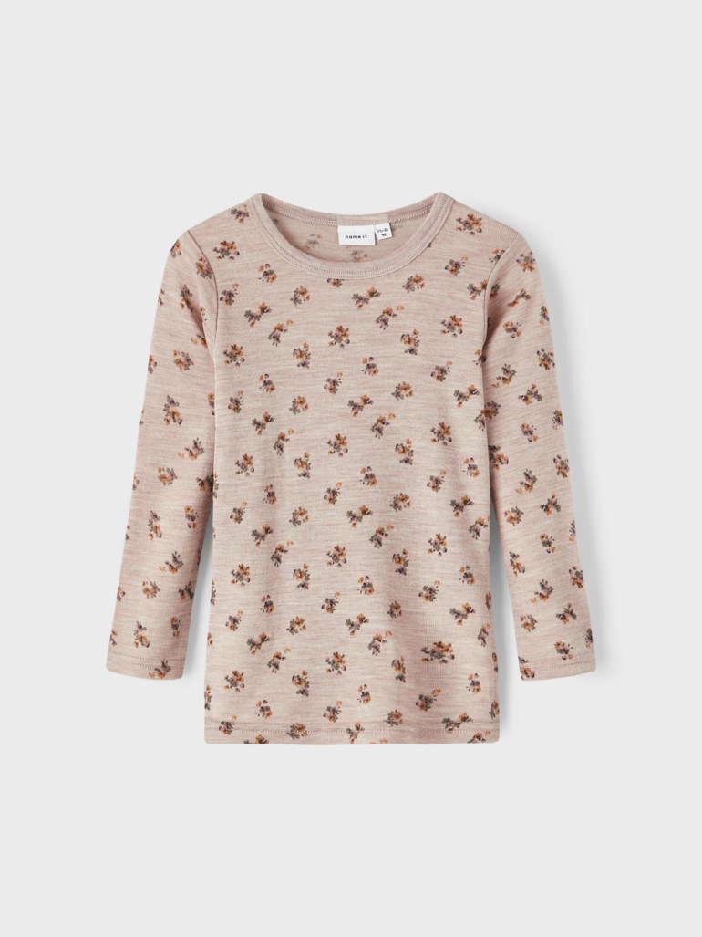 Barns beige langermet topp med lite blomstertrykk, forfra.