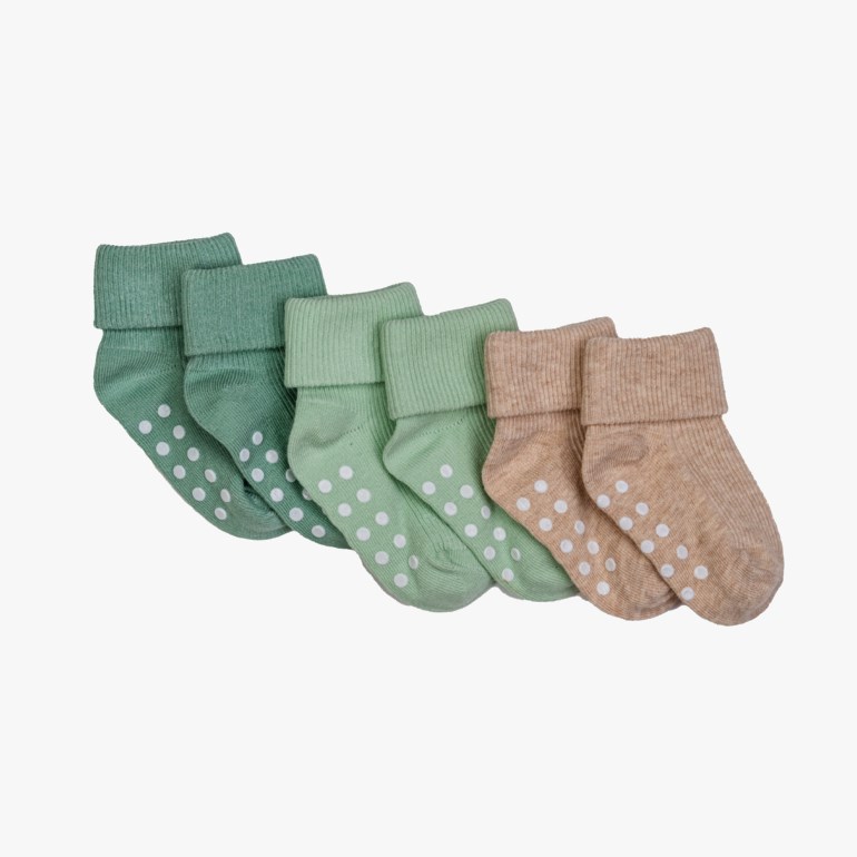 Seks par antiskli babysokker i mørkegrønn, lysegrønn og beige med hvite prikker på sålen.