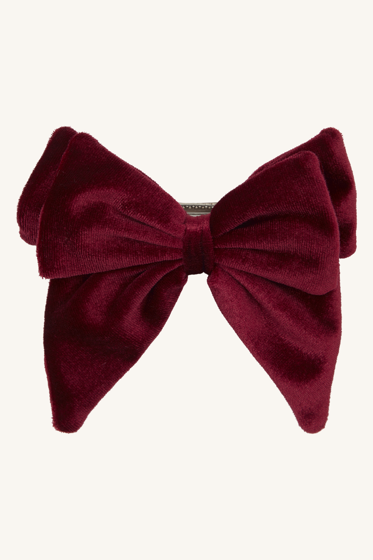 En dyp rød hårsløyfe i fløyel med klassisk design og teksturert stoff.