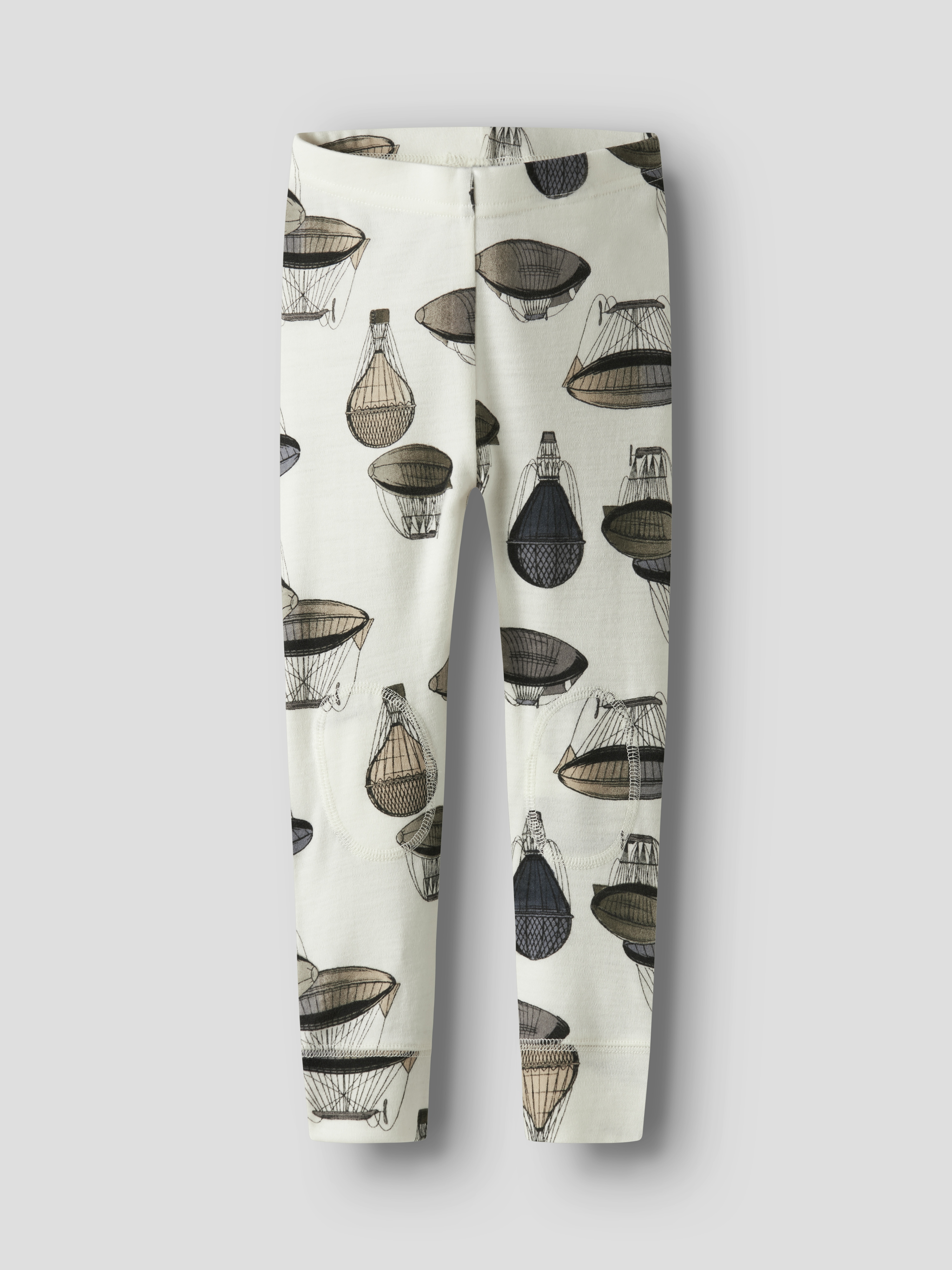 Barnas off-white leggings med et gjentagende mønster av brune og svarte luftballonger, sett forfra.