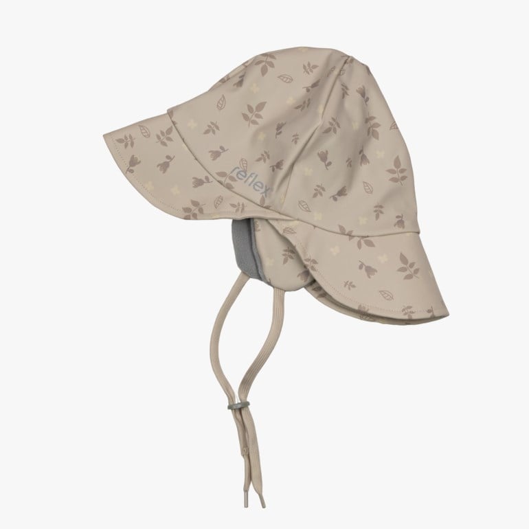 En barne beige vanntett hatt med blomstermønster, bred brem og knytebånd med grått fôr.