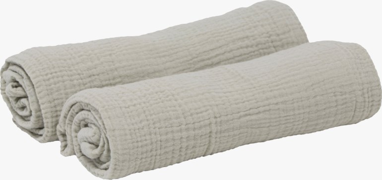 To rullede lysebeige teksturerte musselinkluter.