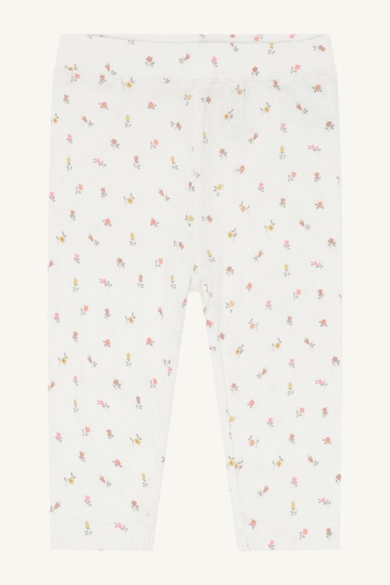 Frontvisning av hvite baby leggings med små spredte flerfargede blomster og elastisk midje.