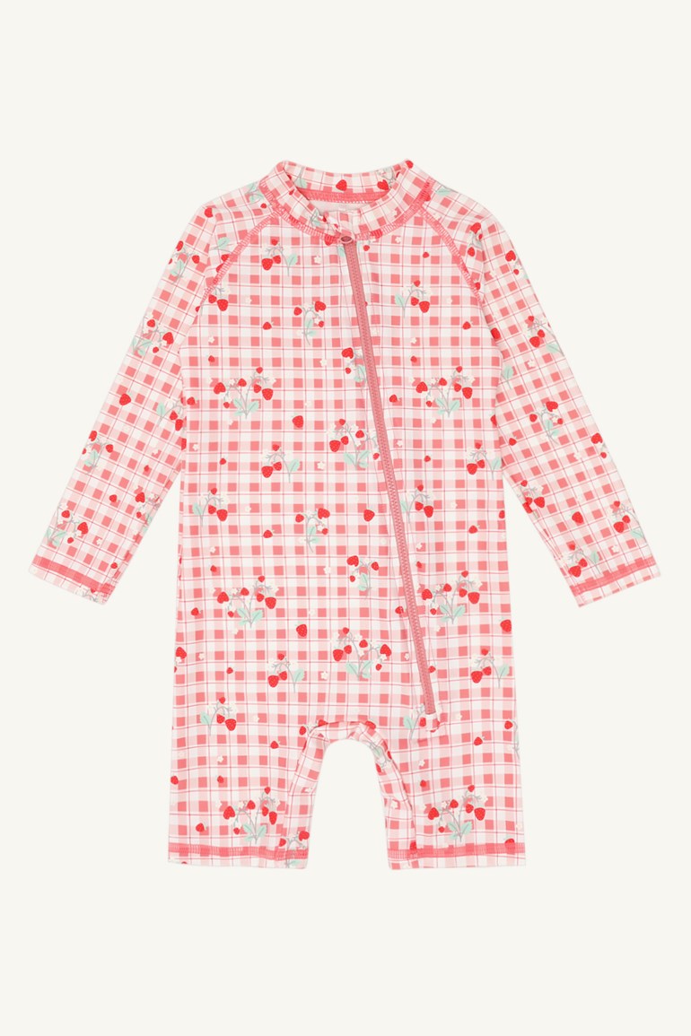En rød og hvit ginghammønstret langermet babysolbadedrakt med jordbærtrykk og glidelås foran.
