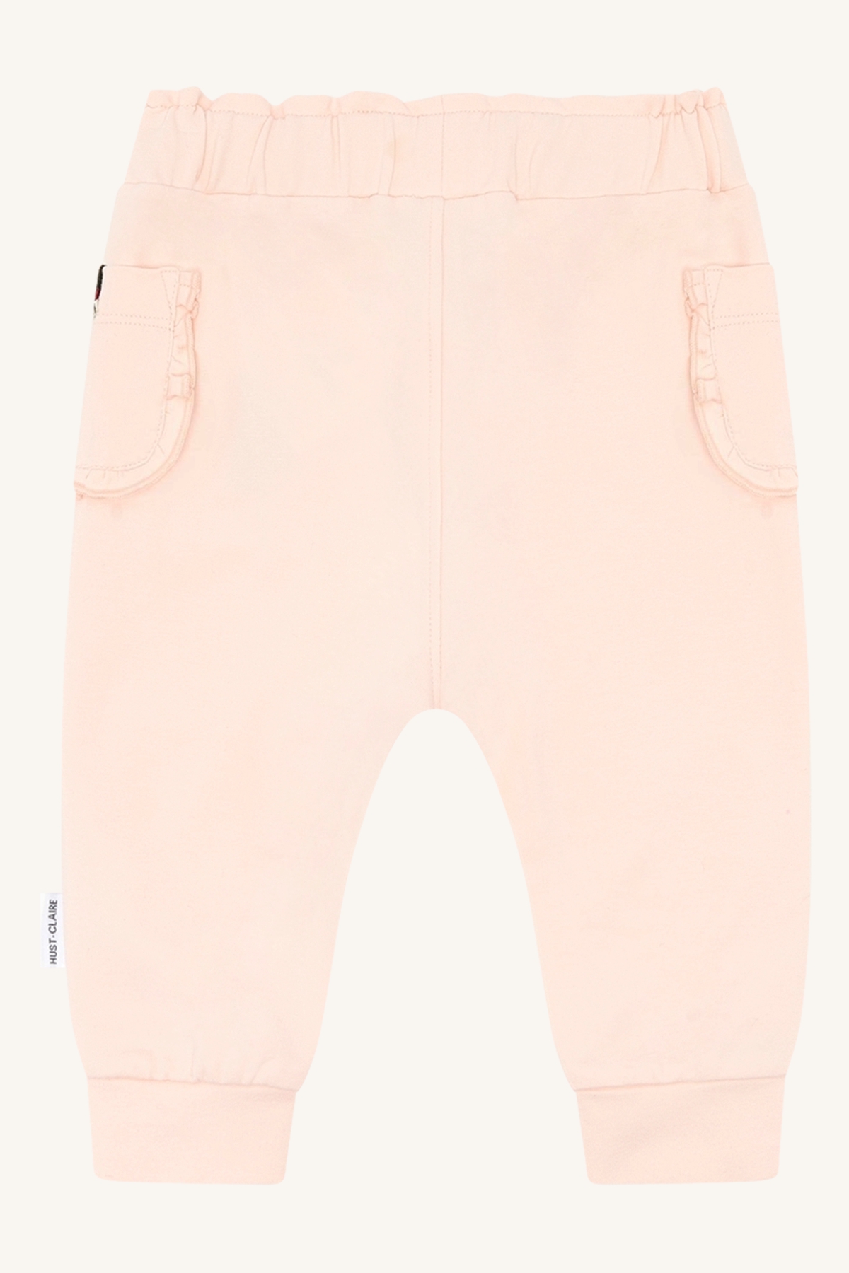 Baby lys rosa bukser med elastisk midje, rysjelommer og ribbestrikkede mansjetter, forfra.