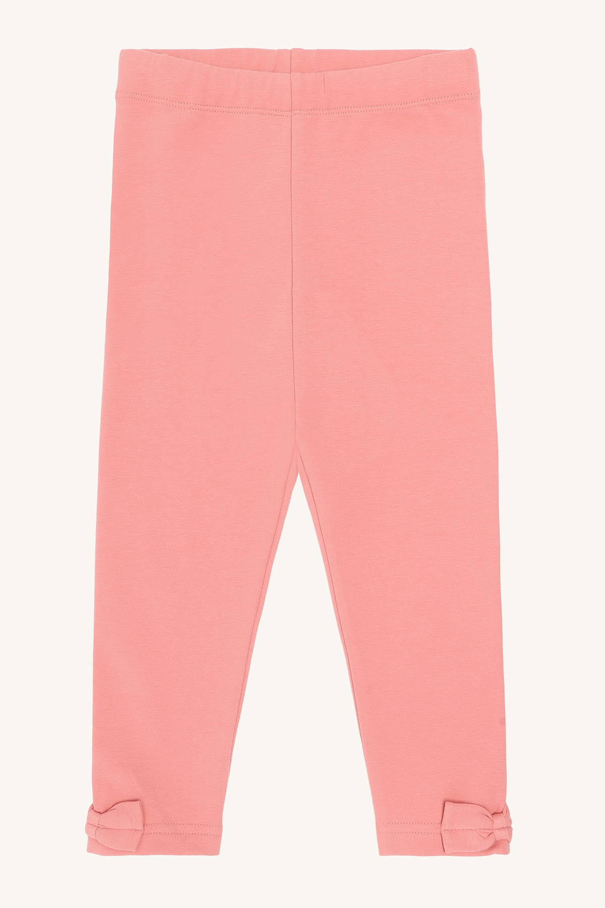 Barns korallrosa leggings med strikk i midjen og små sløyfer ved anklene, forfra.