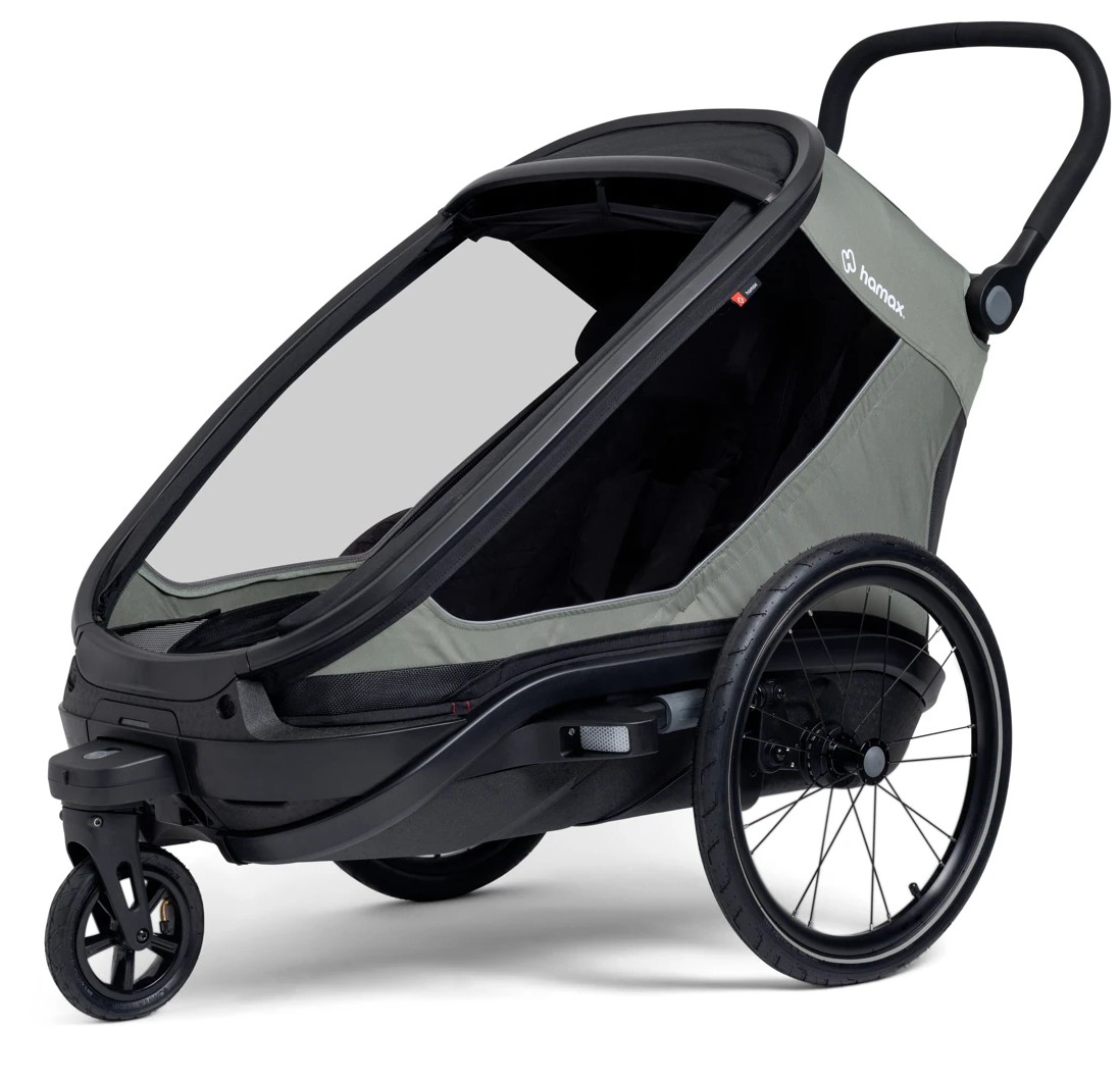 En grå og svart sykkelvogn for barn med klar rute, lite framhjul og store bakhjul.