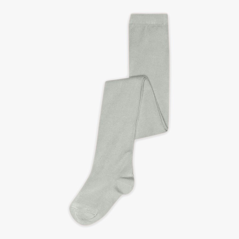 Lysegrågrønne strikkede hellange strømpebukser er brettet.