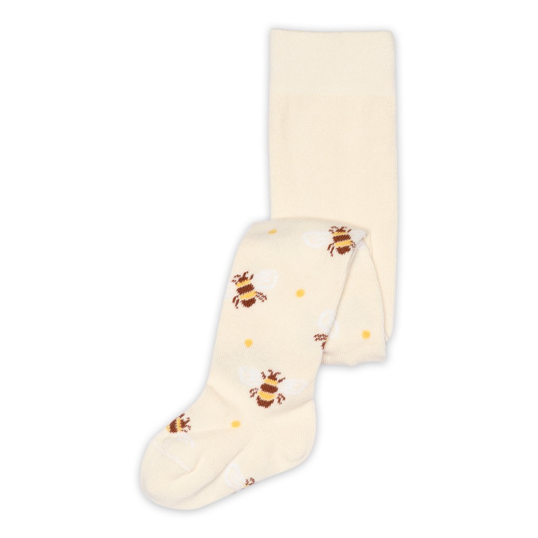 Kremfargede babystrømpebukser med brunt og gult biemønster, brettet flatt.
