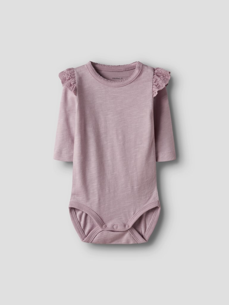 En baby lys lilla langermet body med blondevolanger på skuldrene og trykknapper, forfra.