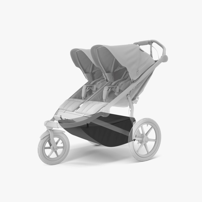 Mørkegrå oppbevaringskurv under en grå dobbel barnevogn, sidevisning.