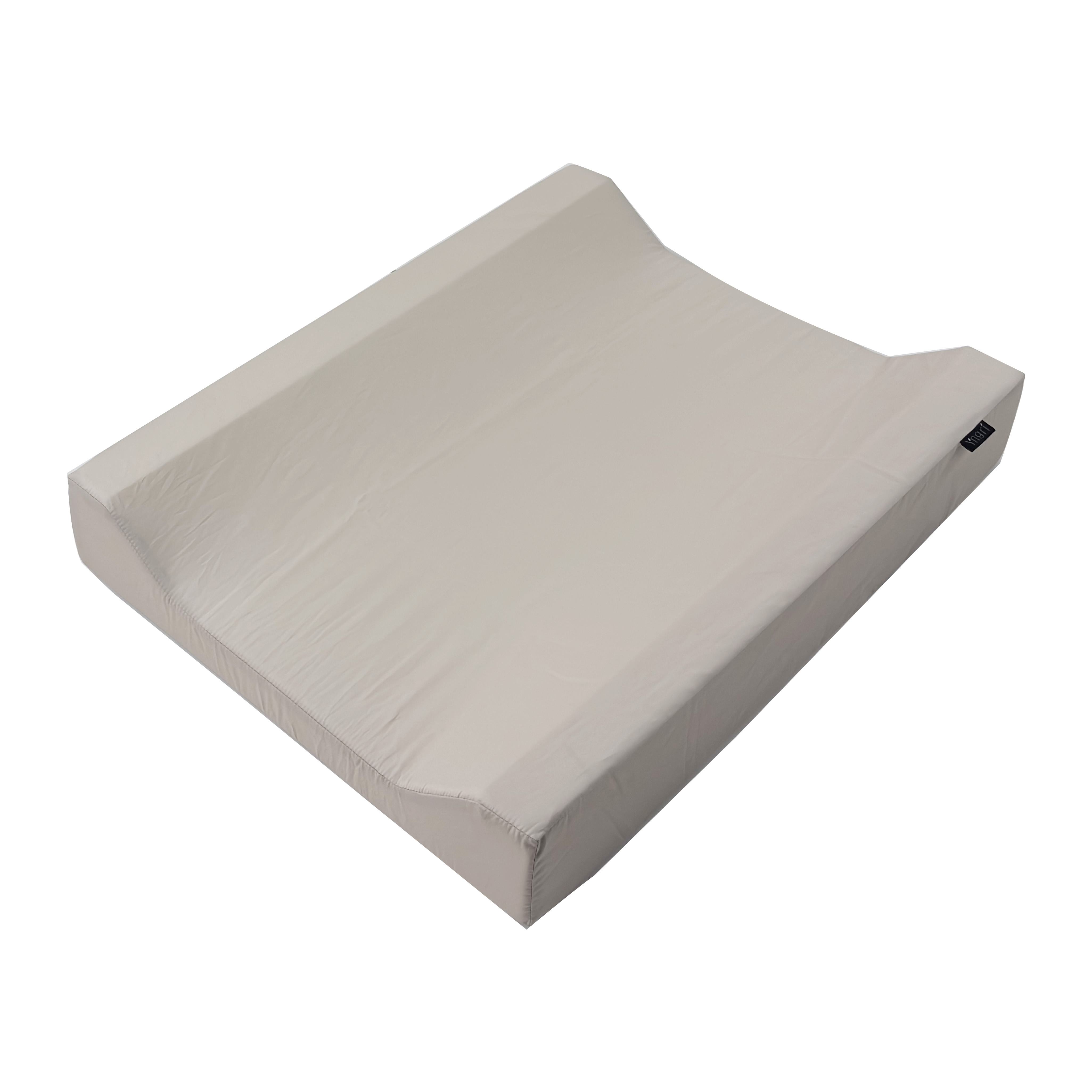 Lys beige rektangulær stellematte med hevede sider og en liten svart etikett, vinklet ovenfra.