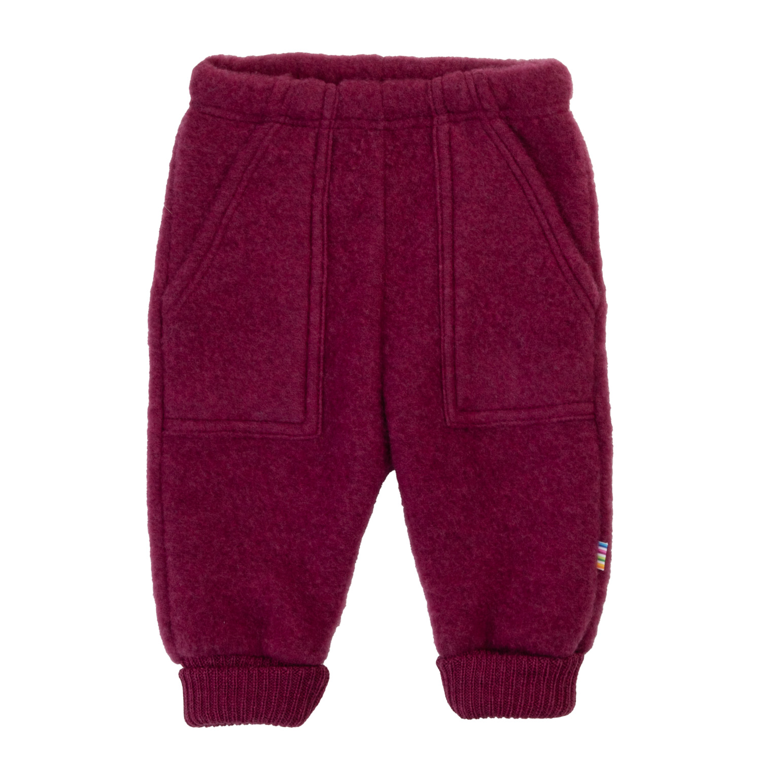 Forfra mørkerøde barnebukser i fleece med elastisk midje, to lommer og ribbestrikkede mansjetter.