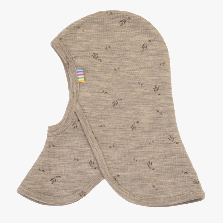 Lys beige barnebalaklava med lite mørkt botanisk trykk og fargerik stripet merke, forfra.