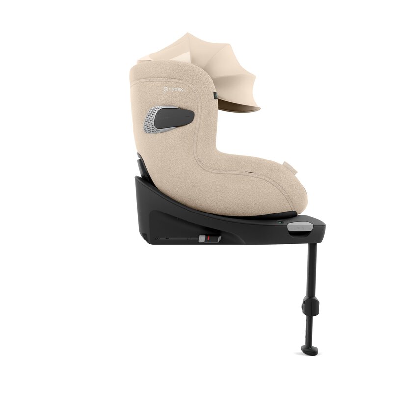 Beige babybilsete med kalesje på en svart ISOFIX-base og støtteben, sidevisning.