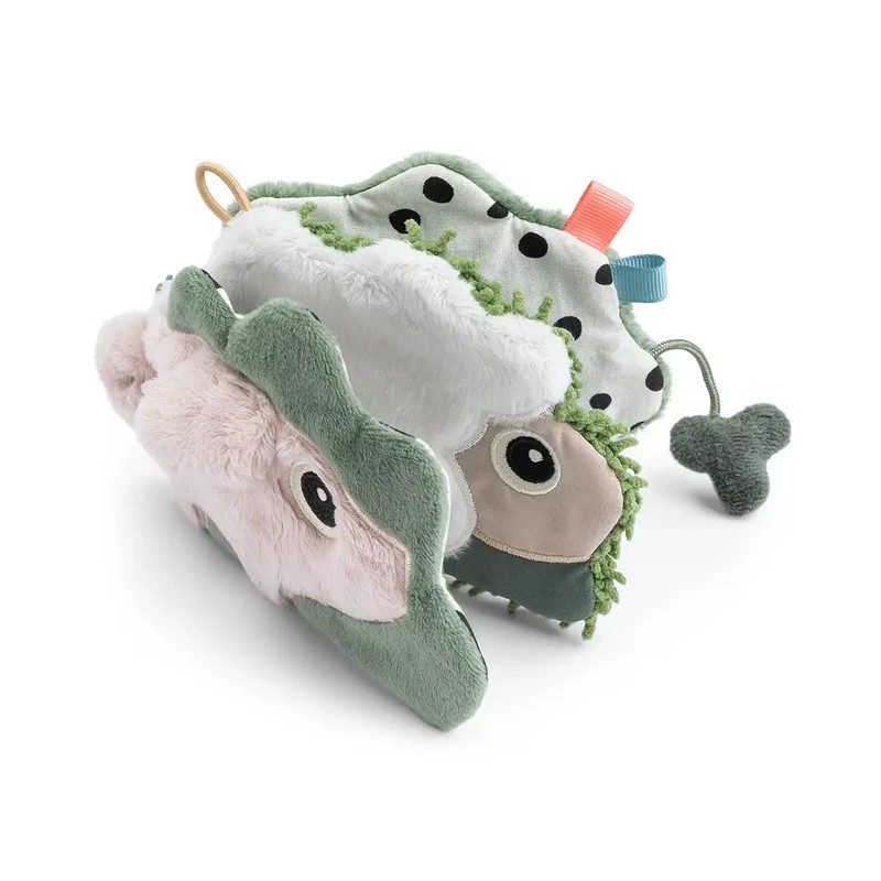 Myk baby aktivitetsbok med grønn, rosa, hvit plysj dinosaur, prikker, teksturer og en dinglende sjarm.