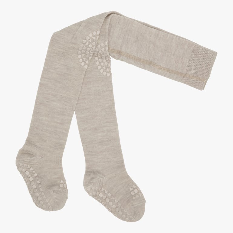 Lysebeige baby tights med antiskli-knotter på føtter og knær og et ribbet midjebånd.