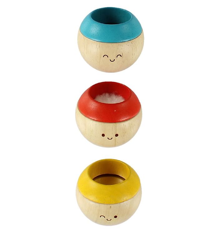 Tre sfæriske treleker med malte smilefjes, med blå, rød og gul topp, en med hvit fluff.