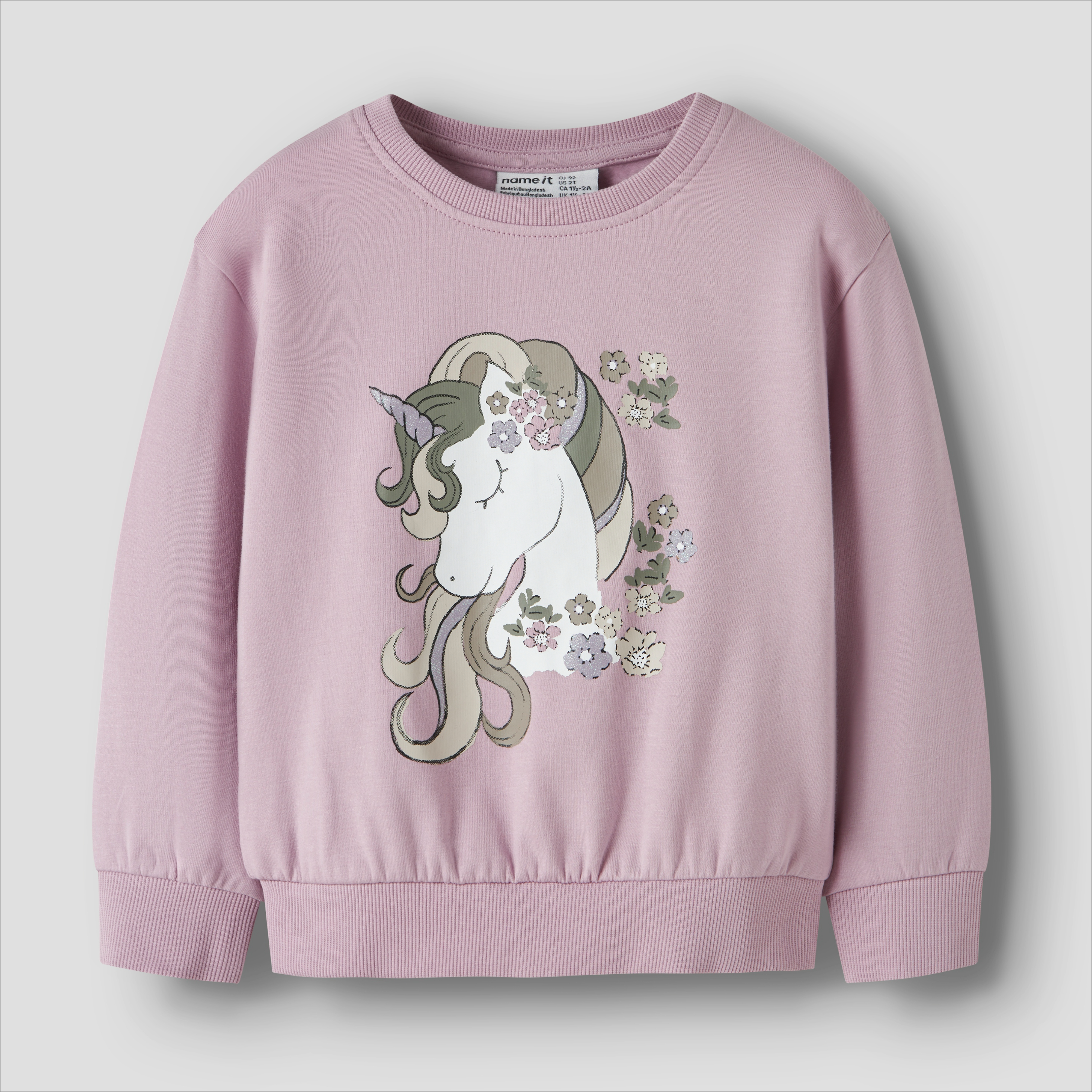 Barnas rosa langermet genser med rund hals og enhjørning blomstertrykk, forfra.