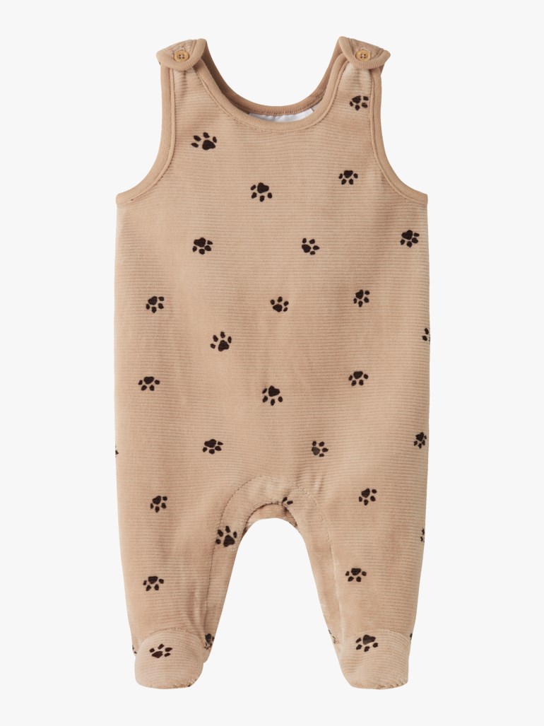 Frontbilde av en beige ribbet babyoverall med brune potetrykk og knapper på skuldrene.